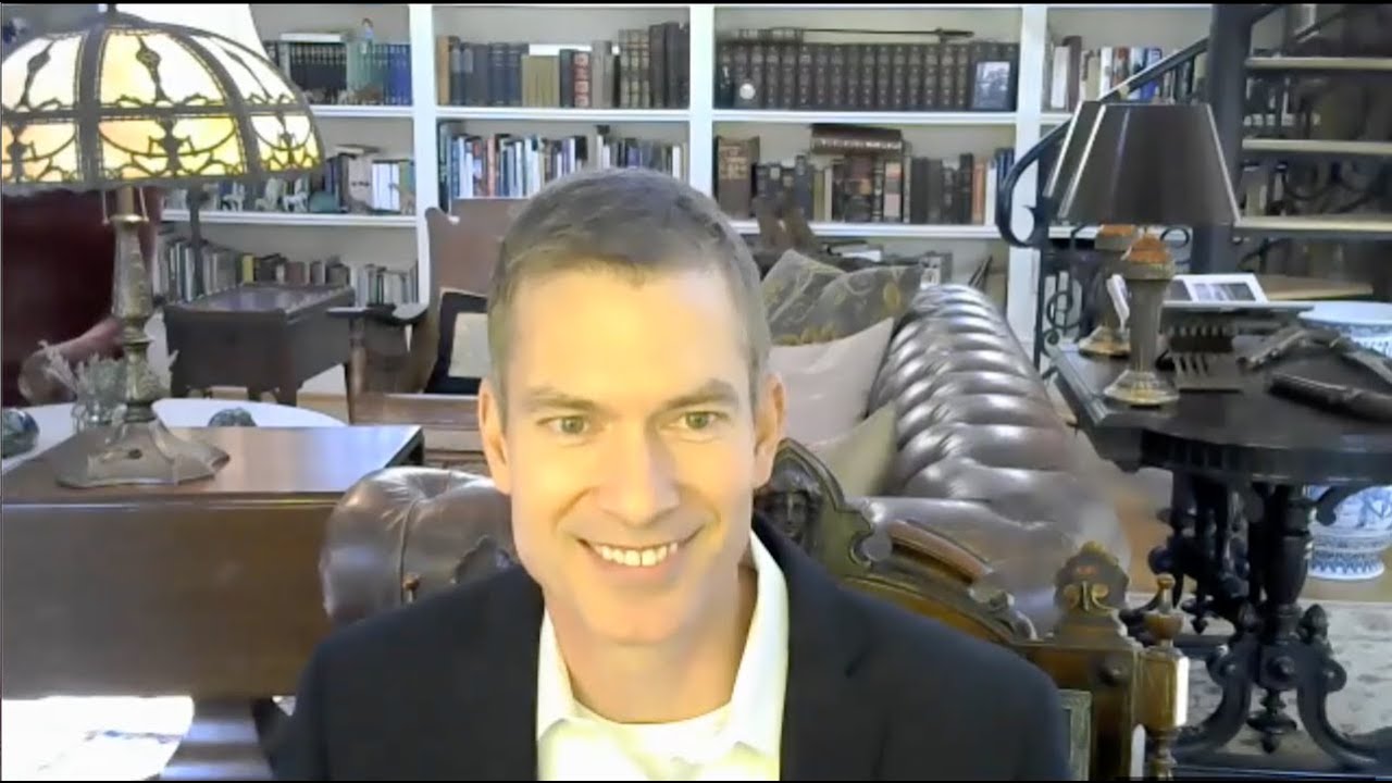 John McCulloch in his library discussing sustainable housing with the Rotary Club of Salem.