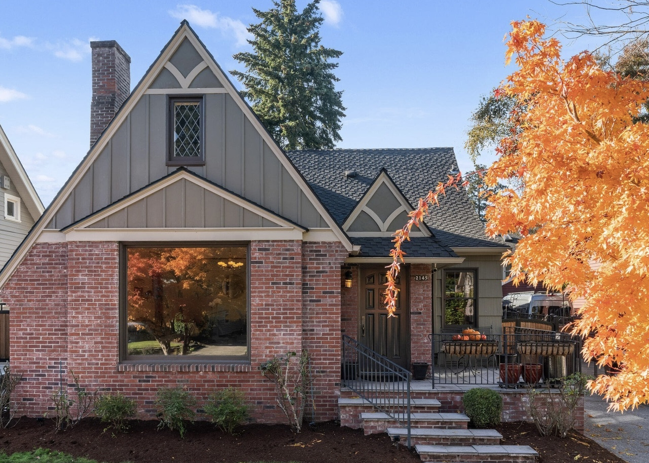 The front facade of the 27th Ave Tudor House. Brick and Tudor style woodworking adorn the front of this renovated home.